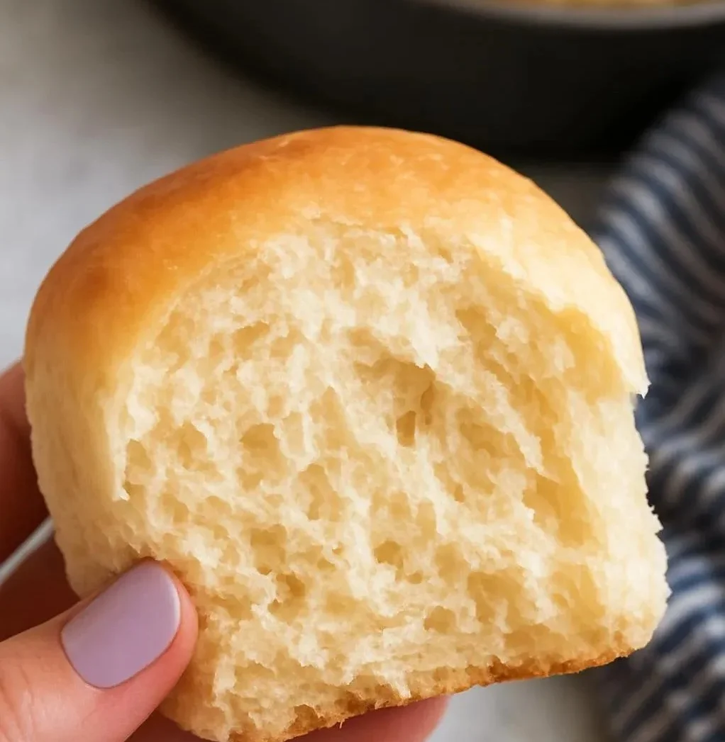 Freshly baked 30-minute dinner rolls on a wooden table