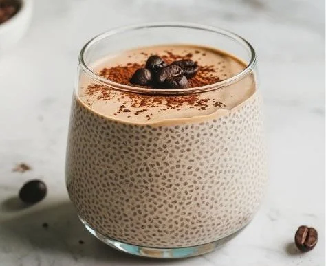 Bowl of coffee chia seed pudding topped with fruits and nuts for a healthy breakfast