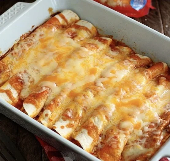 Five-ingredient beef enchiladas ready to serve, topped with cheese and salsa.