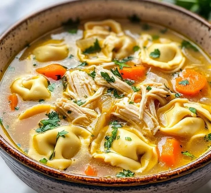 Delicious bowl of easy Chicken Tortellini Soup with fresh herbs