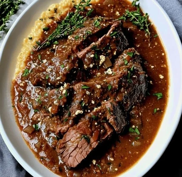 Delicious Stracotto served with vegetables and herbs for a comforting meal