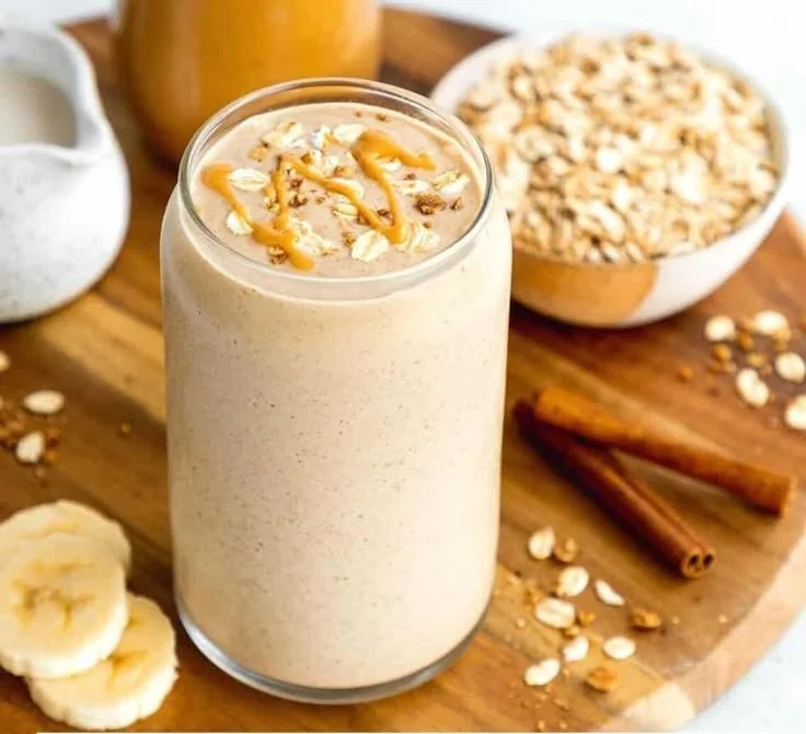 Peanut Butter Oatmeal Smoothie in a glass with toppings