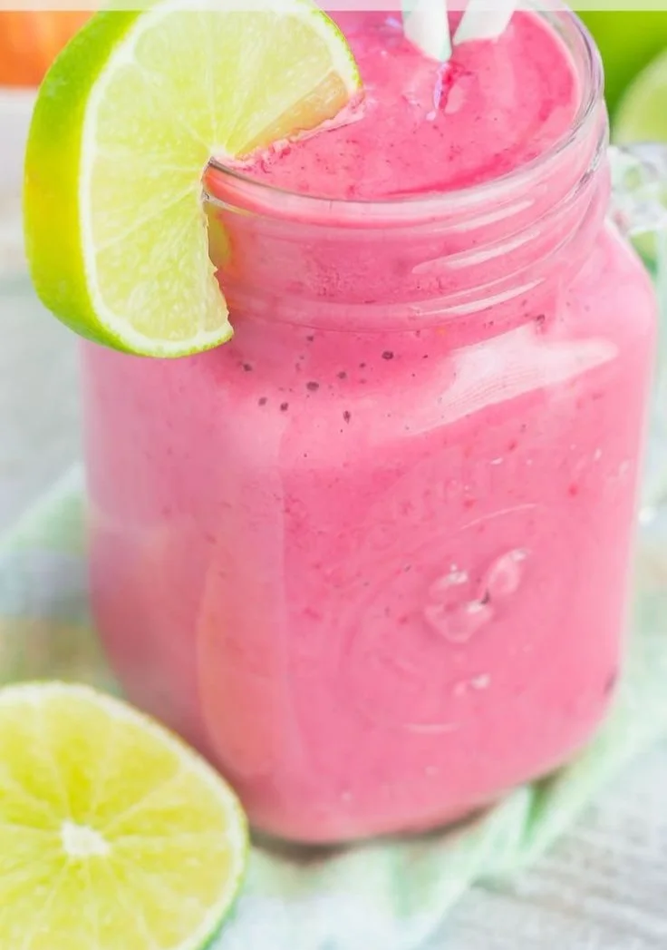 Refreshing Raspberry Lime Smoothie in a glass with fresh raspberries and lime slices