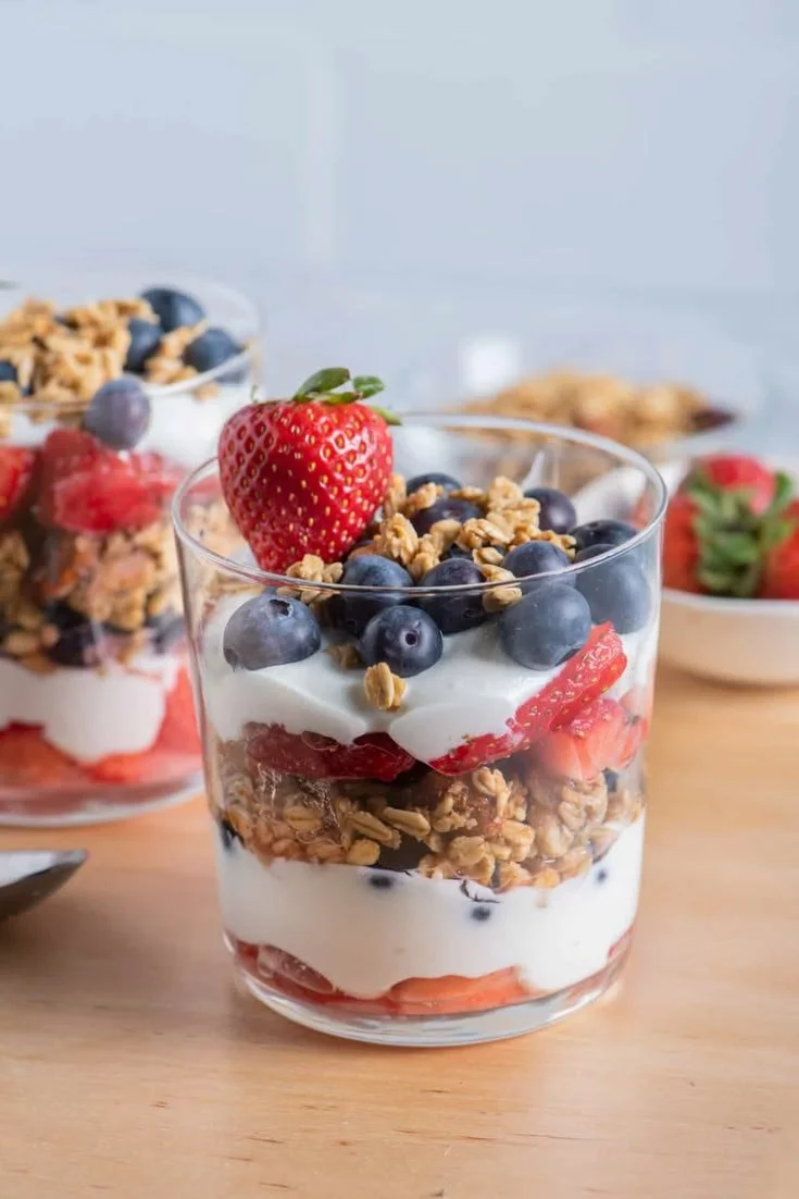 Delicious angel food dessert cups topped with fruit and cream.