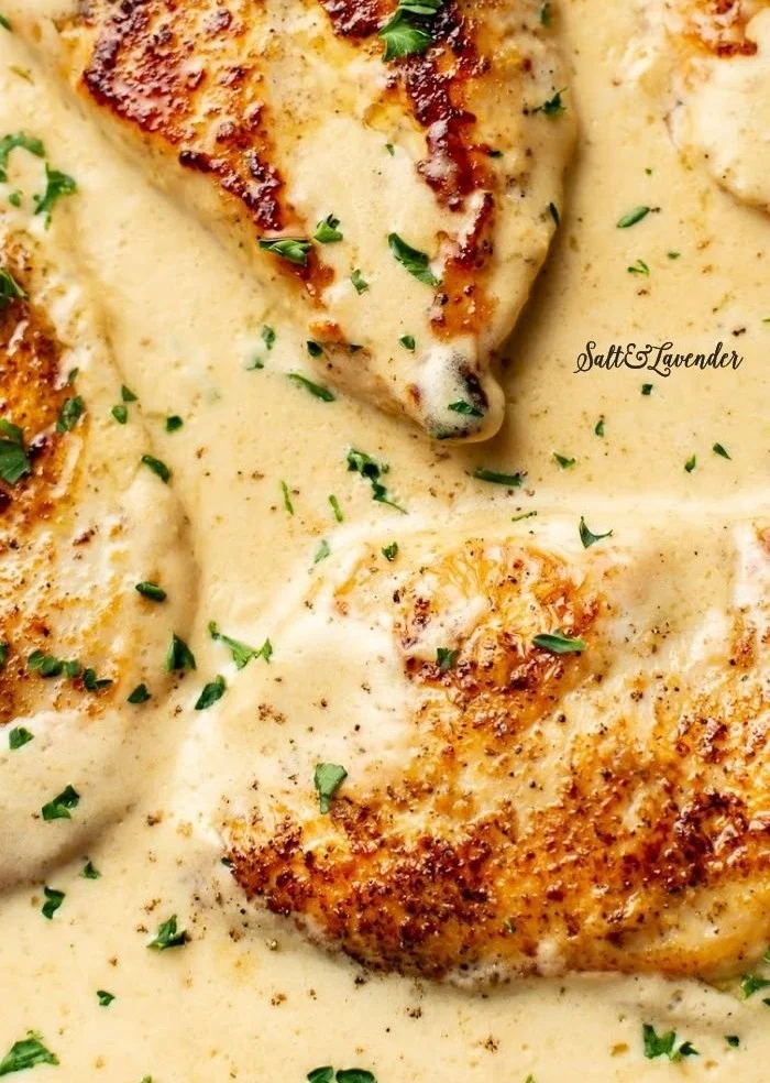 Creamy garlic parmesan chicken dish garnished with herbs